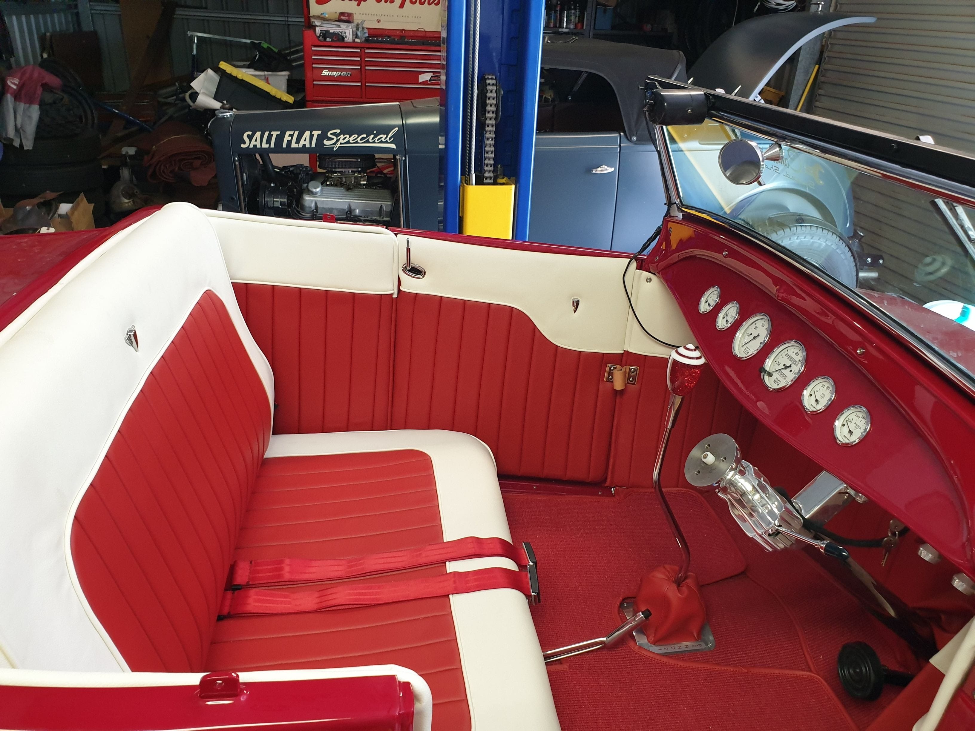Brookville Body hotrod trimmed in red and white vinyl tuck n roll trim. German Square weave carpet